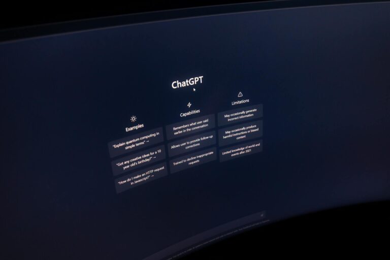 Close-up of a computer screen displaying ChatGPT interface in a dark setting.